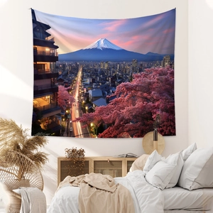Detailed close-up of a Mount Fuji tapestry with cherry blossoms hung over a bedroom wall