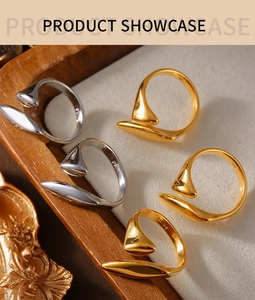 Detail of streamlined 18k gold and silver plated titanium steel rings on velvet display
