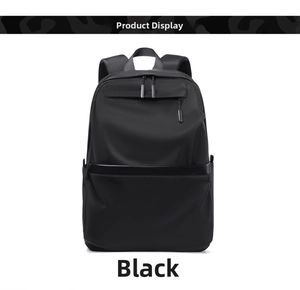 Detail of minimalist black backpack featuring matte fabric and front horizontal zipper pocket