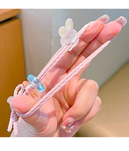 Detailed close-up of a pink elastic hair tie with a white rabbit charm and colorful beads