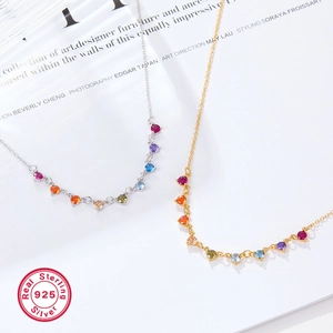 Macro shot of 925 sterling silver necklaces with colorful zircon stones on art book