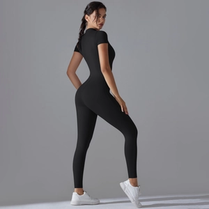 Detail view of high-stretch black athletic jumpsuit showing slim fit and shaping effect