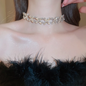 Detailed view of elegant silver rhinestone flower choker necklace on female model neck