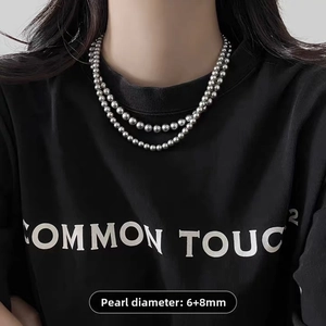 Detail of double-layer silver metal bead necklace with 6mm and 8mm smooth sphere beads