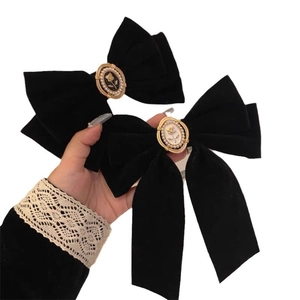 Elegant black velvet bow hair clips with vintage rose relief and pearl embellishments