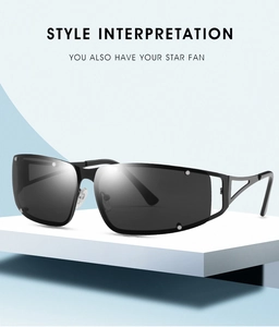 Detail of silver hollowed metal temples and black oversized lenses on Y2K sunglasses
