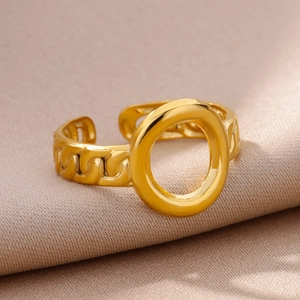 Detailed macro of 18k gold plated stainless steel ring with hollow circle on silk