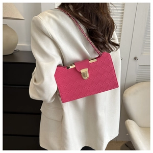 Detail of rose pink woven leather crossbody bag with gold metallic lock and chain strap