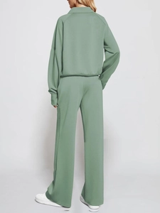 Back view of a sage green lounge set featuring a half-zip sweatshirt and wide-leg pants