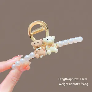 Detailed side view of 11cm alloy hair claw with white pearls and resin bears