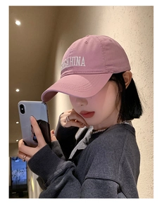 Detail shot of the pink cotton baseball cap with white 3D embroidered EGAHINA lettering