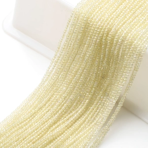 Macro view of 2mm pale yellow faceted glass beads strands for DIY jewelry making