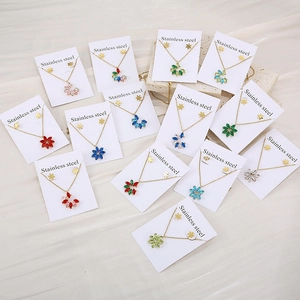 Stainless steel jewelry set featuring colorful zircon flower pendants and matching earrings