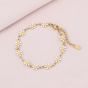 Close-up of a gold daisy petal bracelet with white enamel charms and lobster clasp detail