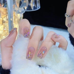 Sparkling pink gradient press-on nails with iridescent glitter and oversized chunky rhinestones