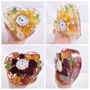 Heart-shaped resin desk clock with dried flowers and Roman numeral dial on white background