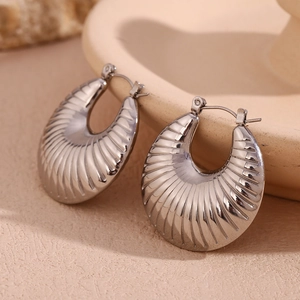 Detailed close-up of silver-tone hoop earrings with embossed striped texture