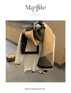 Detail of winter thick cashmere-like scarf with beige black geometric patterns and fringes