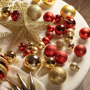 Red and gold Christmas tree ornament set with matte and glitter stars on knit background