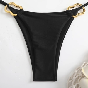 Detail of black bikini bottoms with gold heart-shaped metal rings on side straps