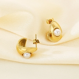 Close-up of 18K gold plated pearl earring on champagne satin with butterfly backing