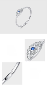 Macro detail of S925 sterling silver evil eye ring with blue and white pavé cubic zirconia