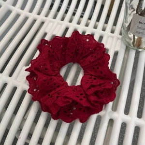 Detailed macro view of the delicate wine red lace scrunchie with floral embroidery