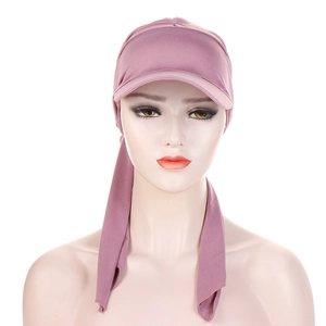 Detail view of purple pleated turban hat with brim and bow tie for women