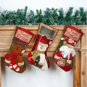 Hanging Christmas stockings with Reindeer, Snowman, and Santa Claus on a wooden mantle