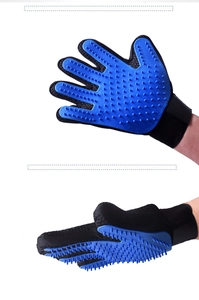 Close-up of blue silicone grooming glove with soft massage tips and breathable mesh