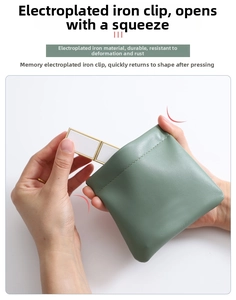 Detail view of mint green leather pouch showing the automatic metal spring closure mechanism