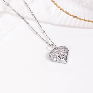 Macro shot of silver heart pendant featuring sparkling cubic zirconia and 18k plating