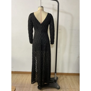 Detailed view of deep V-back design on elegant black sequin mesh long sleeve dress