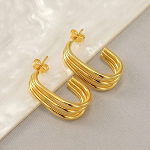 Three-layer 18K gold plated stainless steel U-shaped hoop earrings on marble surface
