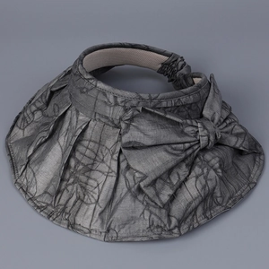 Detailed view of dark grey sun visor hat with pleated brim and large decorative bow