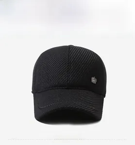 Close-up of black baseball cap with twill texture and star metal badge detail