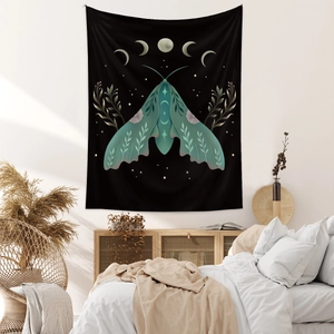 Detail view of bohemian butterfly tapestry with moon phases hanging over a bed in a bedroom
