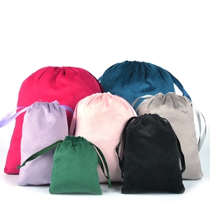 Assorted colors and sizes of premium velvet drawstring pouches on white background