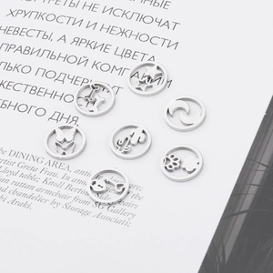 Set of 7 silver hollow metal charms featuring heart, star, moon, and key patterns