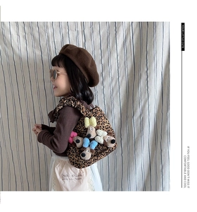Detail of leopard print kids crossbody bag with 3D puppy plush and lettered text