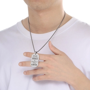 Detail of laser engraved Dad Hero military pendant necklace worn by a male model