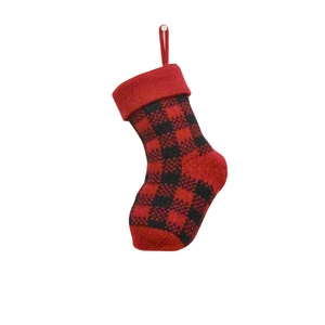 Close-up of a small red and black buffalo plaid knitted Christmas stocking with hanging loop
