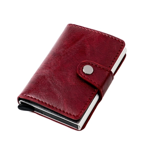 Detail of slim RFID wallet showing dark red leather texture and aluminum card ejector