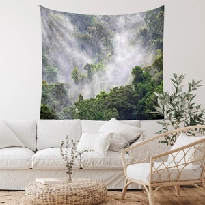 Detail of bohemian forest tapestry hanging in a minimalist living room setting
