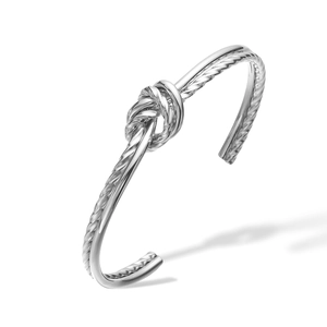 Close-up of a silver twisted rope knot detail on a minimalist stainless steel open cuff bangle