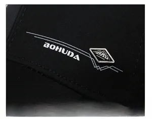 Close-up of black baseball cap with BOHUDA printed text and BHD metal logo detail