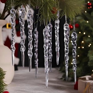 Macro detail of transparent acrylic spiral icicles hanging on green Christmas tree branches