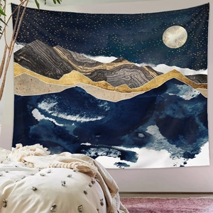 Detailed view of the mountain tapestry featuring blue and gold abstract art under a full moon