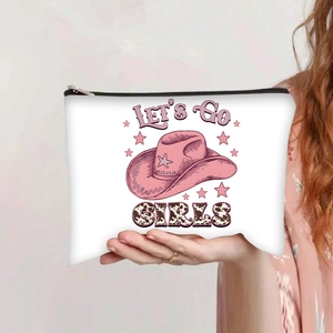 Detail of white canvas makeup bag featuring pink Let's Go Girls print and cowboy hat design