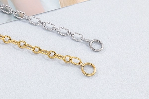 Detail view of gold and silver twisted rope chain bracelets with toggle clasp closures